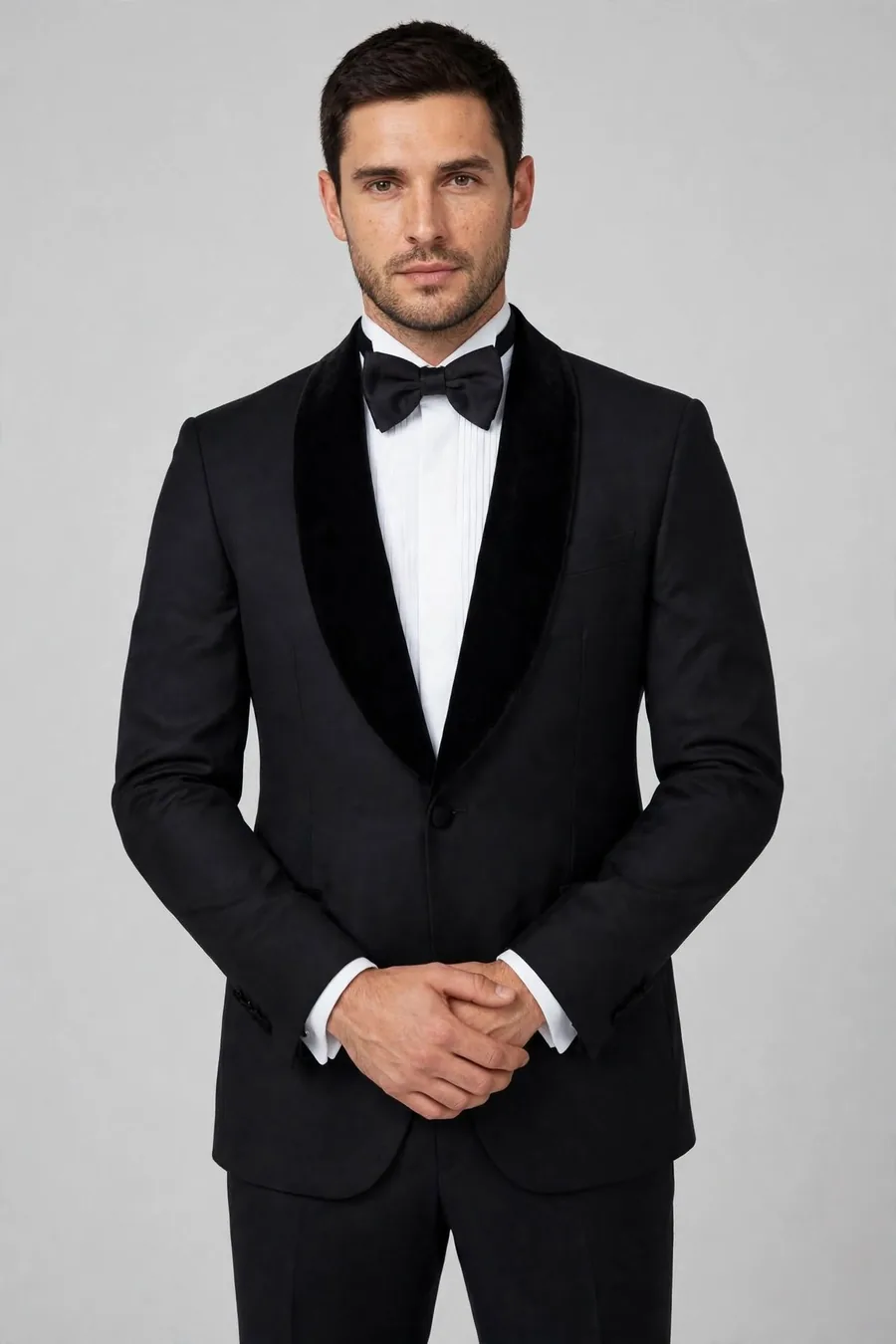 Model wearing a black shawl-lapel groom's suit with bow tie